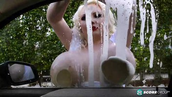 Своими здоровыми большими сиськами опытная блондинка отлично моет машину